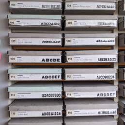 multiple boxes of wood type blocks in a shelf